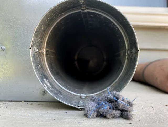 Hudson Dryer Vent Cleaning technician using specialized equipment to clear severe dryer vent blockage in Hudson